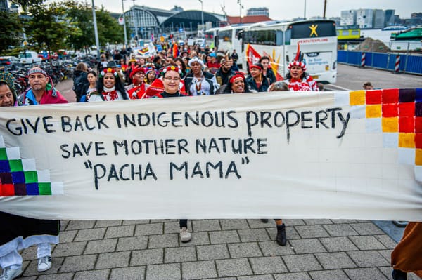 Give Back Indigenous Property Save Mother Nature Pacha Mama sign, people marching